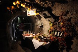 a table set up in a tunnel with food on it at Rooms Malina I Peaceful Stay Near Bled & Mountain Views in Blejska Dobrava
