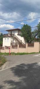 a white house with stairs on the side of it at Gábor - lak in Miskolc