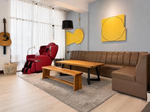 a living room with a couch and a table at 大樹林 Mori Mori 包棟民宿 寵物友善 附車位 in Tainan