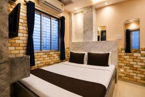 a bedroom with a bed in a brick wall at Saba Guest House in Kolkata +114 photos