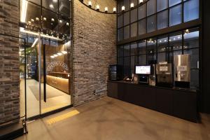 a store front with a display case in a brick building at 브라운도트호텔동탄역점 구 js더클래식호텔 in Hwaseong