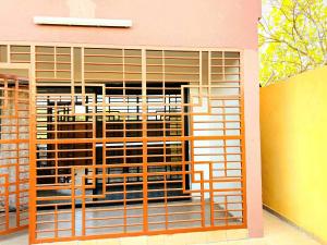 a pink building with a large window with metal gate at Prestige A4 in Ouagadougou