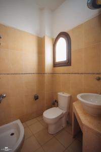 a bathroom with a toilet and a sink at El Salam hotel in Dahab +52 photos