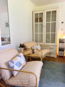 a living room with two chairs and a table at The lighthouse in St Ives