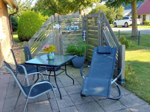 a table and chairs sitting next to a fence at Ferienwohnung Paula, Kluis in Gagern