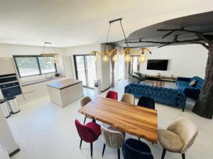 a living room with a table and some chairs at Villa LiRa Star Bar Montenegro - Exclusive Adriatic Villa with Private Pool Starry Sky Lounge in Stari Ulcinj
