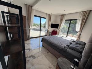 a bedroom with a bed and a large window at Villa LiRa Star Bar Montenegro - Exclusive Adriatic Villa with Private Pool Starry Sky Lounge in Stari Ulcinj +54 photos