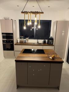 a kitchen with a island with a sink in it at Villa LiRa Star Bar Montenegro - Exclusive Adriatic Villa with Private Pool Starry Sky Lounge in Stari Ulcinj