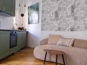 a living room with a couch and a table at La Cathédrale in Soissons