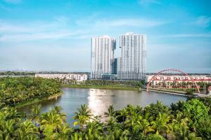 a view of a river with tall buildings and a bridge at Maison Joie Ecopark Lighthouse Ecorivers Hải Dương in Hải Dương