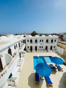 a view of a building with a pool and umbrellas at El Salam hotel in Dahab