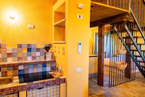 a yellow room with a staircase and a yellow wall at Il Casotto tra i Vigneti in Nizza Monferrato