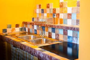 a kitchen with a sink and colorful tiles at Il Casotto tra i Vigneti in Nizza Monferrato