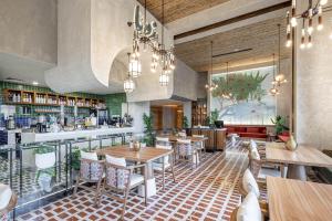 a restaurant with tables and chairs and a bar at Citadines Abha in Abha