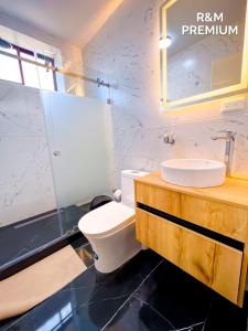a bathroom with a toilet and a sink at El rincón de Valentina in Pelileo +21 photos