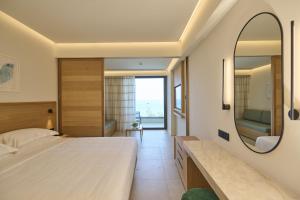 a bedroom with a large bed and a mirror at Sunrise Emerald in Protaras +89 photos