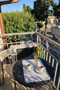 a table with two cups of coffee on a balcony at BlueSkyLite in Taormina