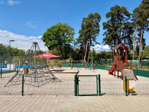 a playground with two slides and a swing at Hotel Prokopávka in Pilsen