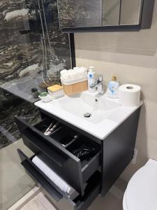 a bathroom with a sink and a toilet at Urban Central Hub in Giurgiu +20 photos