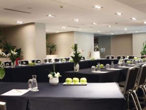 a conference room with tables and chairs and flowers at Mövenpick Hotel Casablanca in Casablanca +219 photos