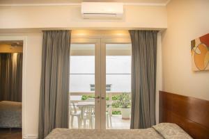 a bedroom with a bed and a window and a table at Hotel Selent in Mar del Plata
