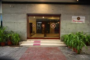 a entrance to a store with plants in front of it at Dhanunjayas Luxury Hotel in Hosūr