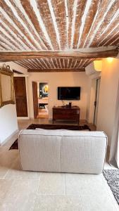 a living room with a couch and a piano at Bastide Sainte Trinide in Sanary-sur-Mer