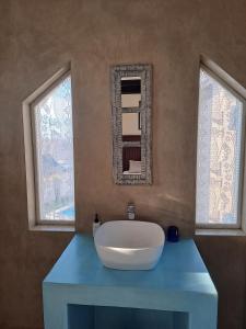 a bathroom with a white sink and two windows at Stone Crown Manor B&B in Mossel Bay +49 photos