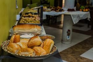 a bunch of bread in a basket on a table at Hotel Maciel in Ponta Grossa