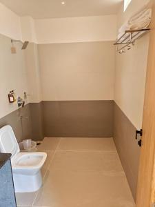 a bathroom with a toilet and a sink at Trivera in Pidugurālla +7 photos