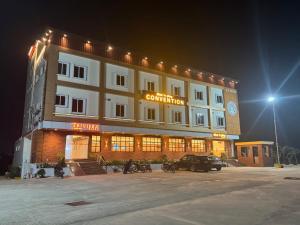 a large building with a car parked in front of it at Trivera in Pidugurālla