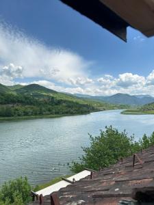 a view of a river with mountains in the background at Restoran Orahovica Konjic - sobe in Konjic