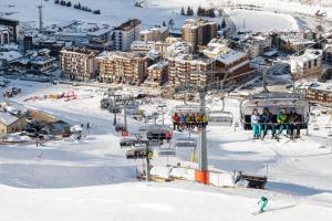 a group of people on a ski lift in the snow at Maison Rêve Blanc - Panoramic Ski in - Ski out in Breuil-Cervinia