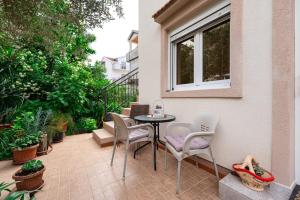 a patio with a table and chairs and a window at Apartments Gabi&Zdenka Tivat in Tivat +98 photos