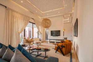 a living room with a couch and a table at Luxury Marrakech Villa marrakech pool,staff,brekfast included in Marrakesh