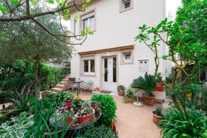 a garden in front of a house with plants at Apartments Gabi&Zdenka Tivat in Tivat