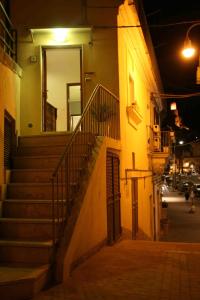 a staircase leading to a building at night at Modica Suite in Modica