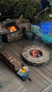 a fire pit on a wooden deck with a table and a table at Villa Sol - Wilderness in Wilderness