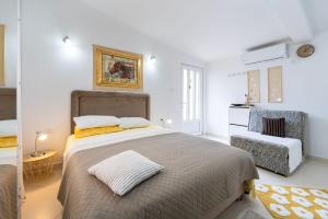 a bedroom with a large bed and a chair at Apartments Gabi&Zdenka Tivat in Tivat