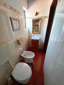 a small bathroom with a toilet and a sink at Casa da Torre in Sao Pedro de Tomar