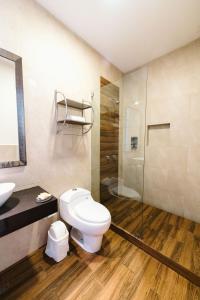 a bathroom with a toilet and a glass shower at Villa Oasis in Ica +55 photos