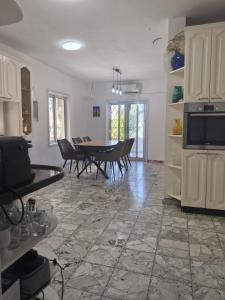 a kitchen and dining room with a table and chairs at private house near Jerusalem in Beit Shemesh
