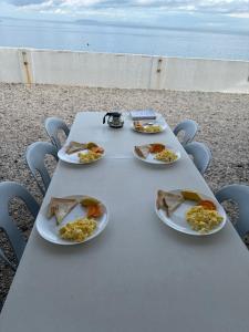 a picnic table with plates of food on it at Villa Ebarle Diving Resort in Mabini