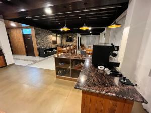 a large kitchen with a counter top in a room at Manali Se - Your Home in the Pines in Jagatsukh