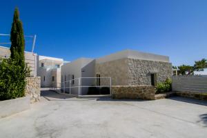 a large stone building with a driveway in front of it at serene villas in Ierapetra