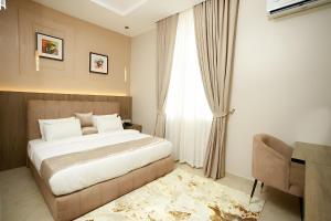a bedroom with a bed and a window at Habor Hotel & Suites- Abuja in Abuja +27 photos