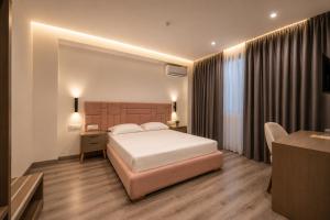 a hotel room with a bed and a desk and a room at Hotel Mare 2 in Ksamil +37 photos