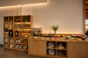 a bakery counter with various food items on it at Hotel Mare 2 in Ksamil