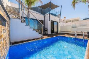 a swimming pool in the backyard of a house at Villa Miragem Alvor in Alvor