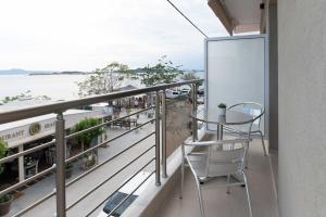 a balcony with a table and chairs and the ocean at Maistrali Luxury Living in Ouranoupoli